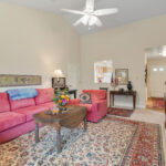 A kitchen pass through allows natural light and conversation to flow from the living room to the heart of the house.