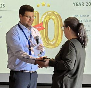 Mike Youmans congratulates Kori for her accomplishments.